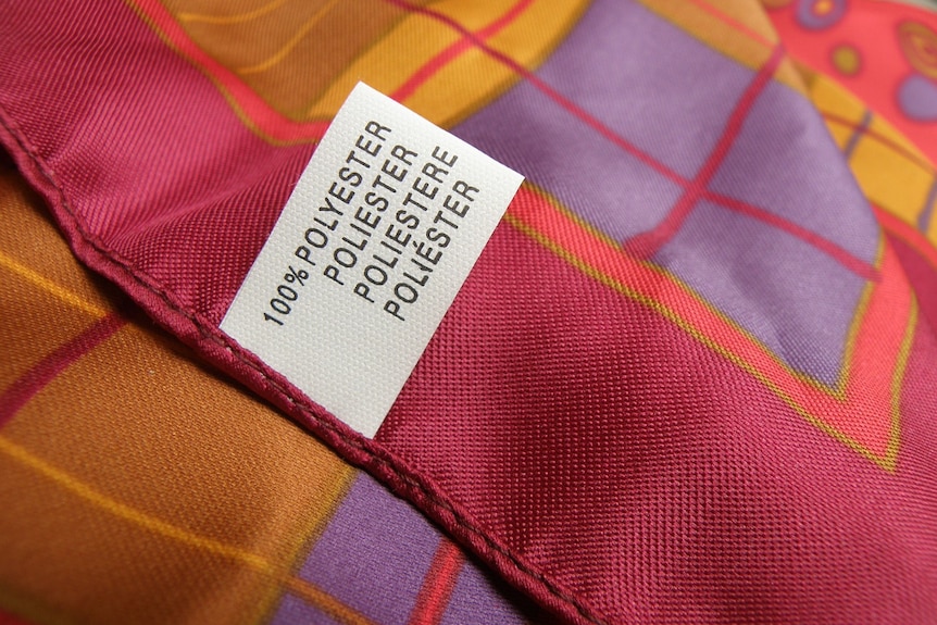 A pink, orange and purple scarf and a tag that says 