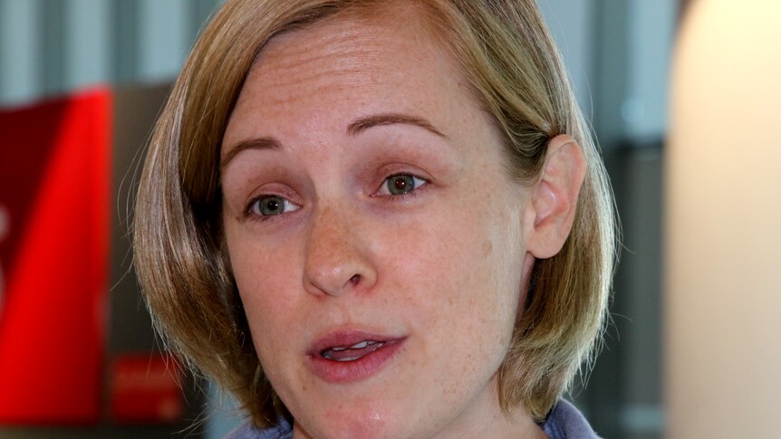 A close up of the face of a woman with blonde hair