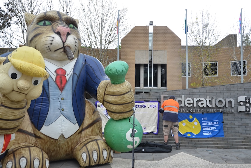 An inflatable 'fat cat' next to a Federation University sign