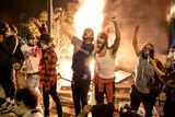 Protesters celebrate setting a police station on fire in Minneapolis.