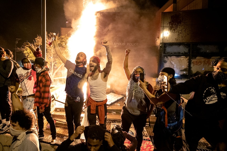 Protesters celebrate setting a police station on fire in Minneapolis.