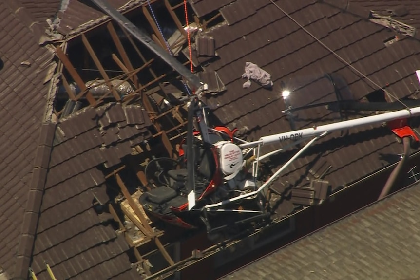 A damaged helicopter crashed into the roof of a house.