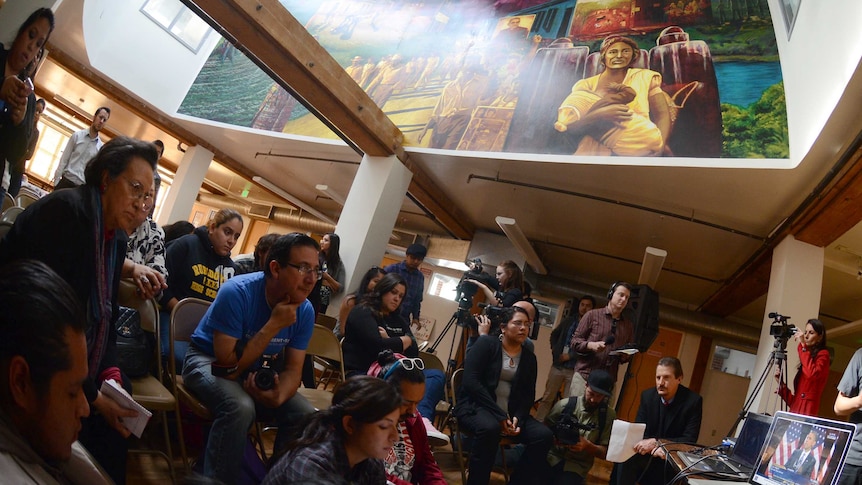 Activists at the Central American Resource Centre in Los Angeles watch as Barack Obama delivers his immigration plan.