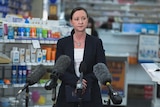 Yvette D'Ath gives a press conference in a pharmacy