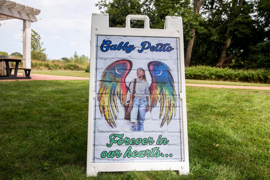A placard depicting Gabby Petito as an angel reads 'forever in our hearts'