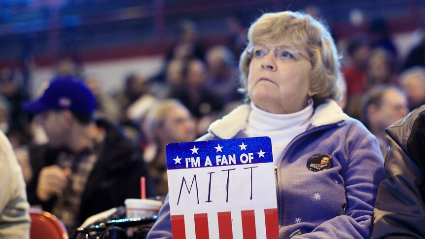 A fan of Mitt Romney waits for him to speak.