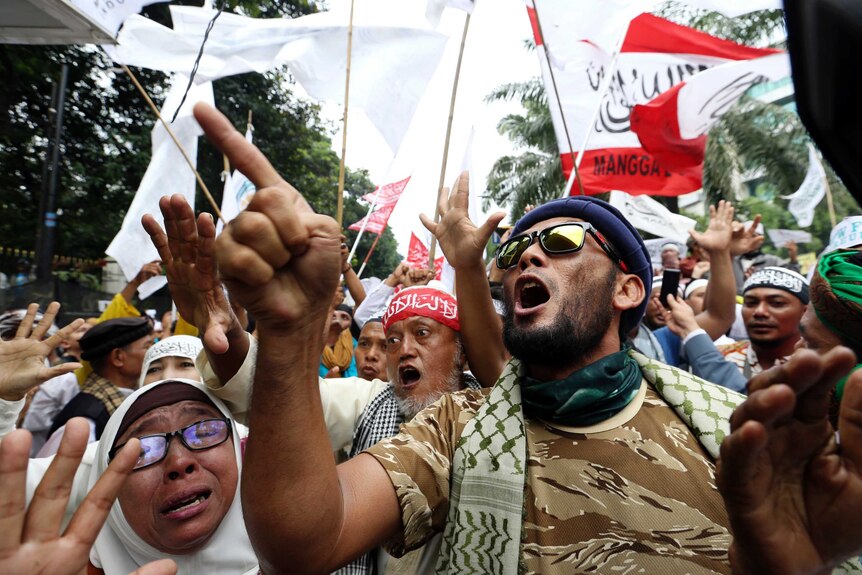 Muslim protesters shout slogans during a protest against Jakarta's Christian Governor Basuki "Ahok" during his trial.