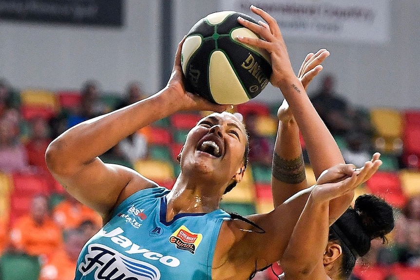 Liz Cambage with the ball against the Townsville Fire during the 2020 WNBL season.