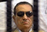 Ousted Egyptian president Hosni Mubarak sits inside a cage in a courtroom during his verdict