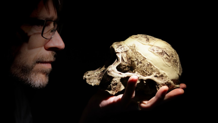 A man holding a skull