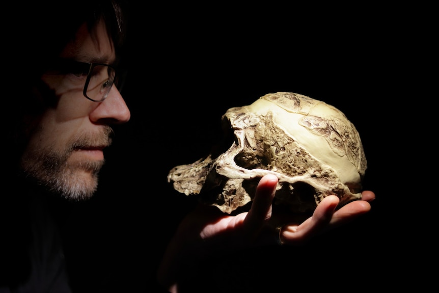 A man holding a skull