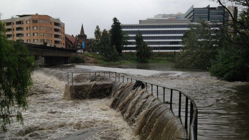 The Parramatta River floods during a downpour in Sydney which caused chaos on roads, people being trapped in cars and damage to homes.