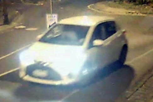 A small white Toyota Yaris coming out of a roundabout in Fitzroy in 2016.