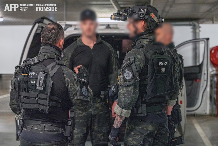 a group of police officers in riot gear