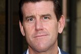 Ben Roberts-Smith looks at the camera outside a court building