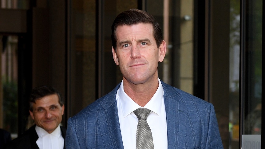 Ben Roberts-Smith looks at the camera outside a court building