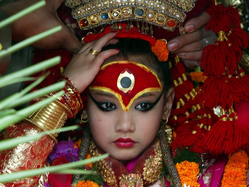 Young girl in elaborate costume and head dress