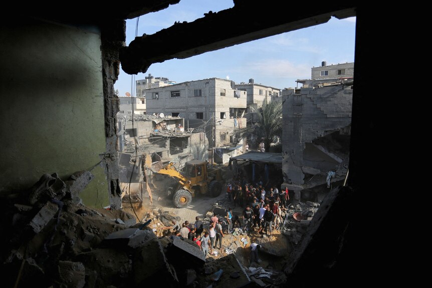 Palestinians conduct search and rescue works at the site of an Israeli strike on a house in Rafah.