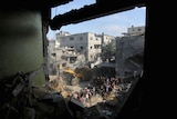 Palestinians conduct search and rescue works at the site of an Israeli strike on a house in Rafah.