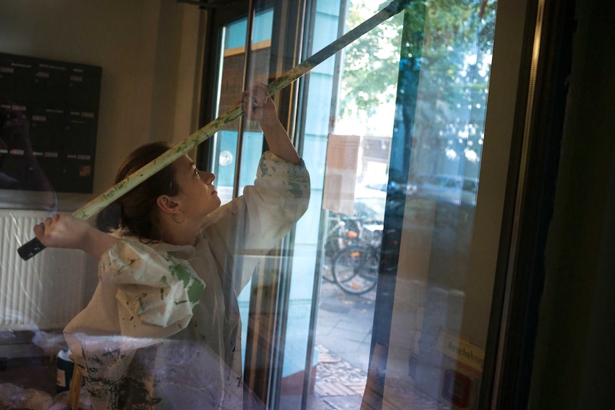 Maria painting the entrance at Refugio.