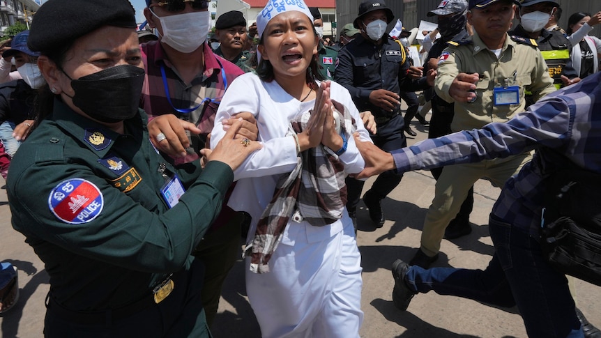 A woman being arrested by police. 