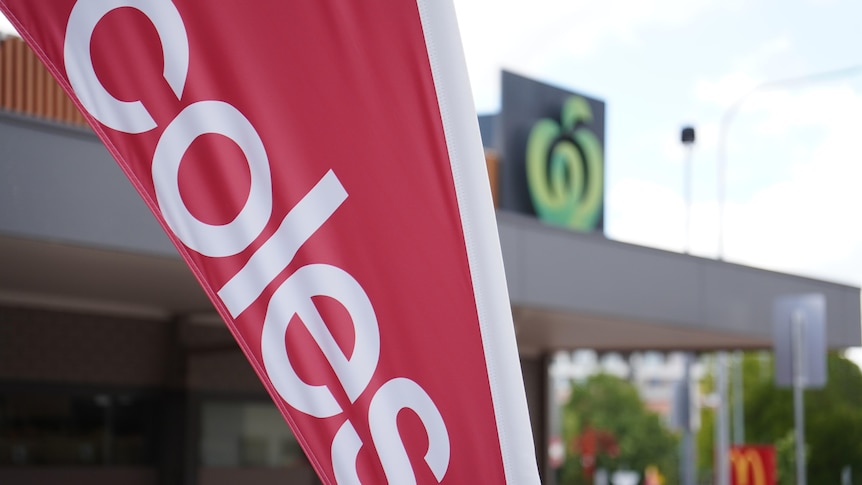 Coles and Woolworths branding outside neighbouring supermarkets