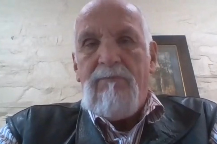 A retired gentleman on a zoom call from his home