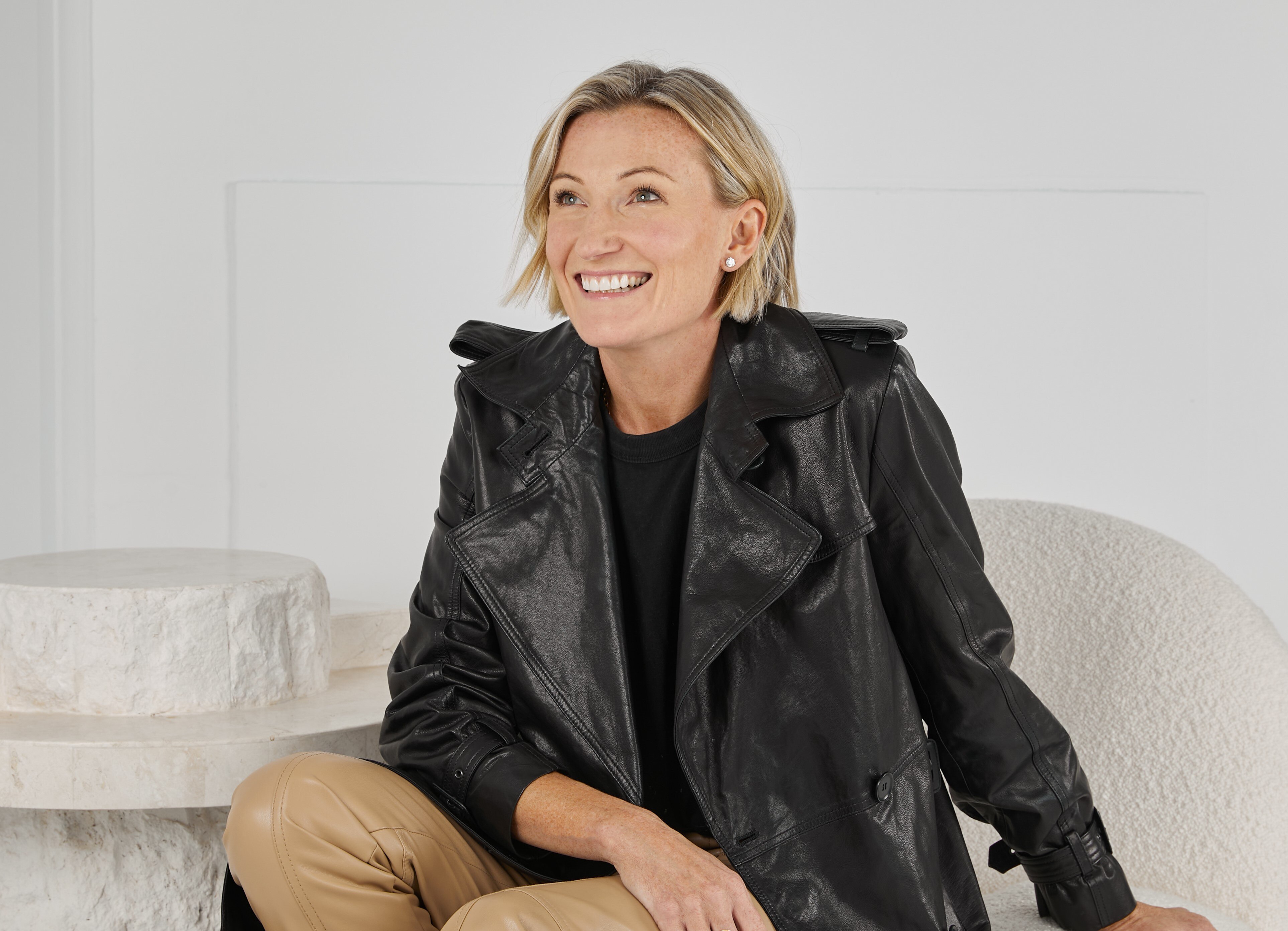 Anna Baird sitting down, wearing a black leather jacket.