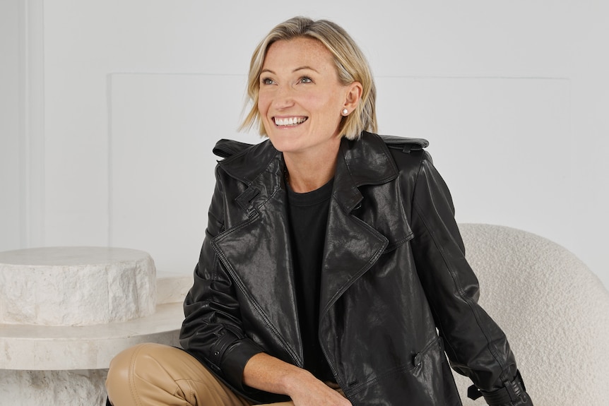 Anna Baird sitting down, wearing a black leather jacket.