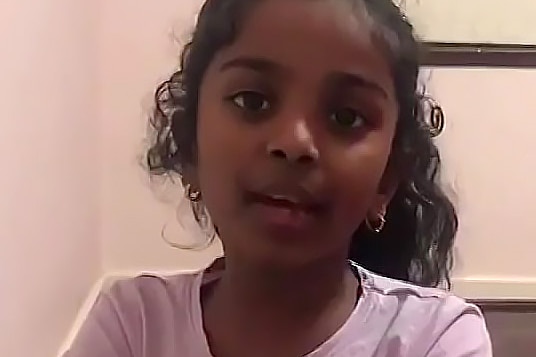 Headshot of a young girl in a pink top