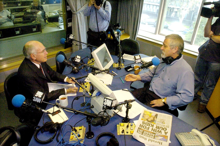 John Howard and Neil Mitchell in a radio studio.