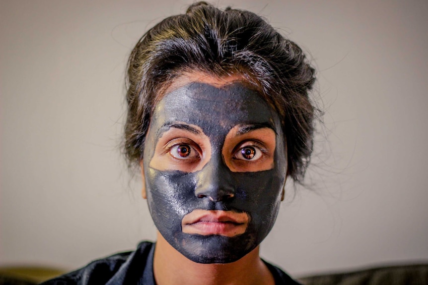 Woman wearing grey face mask.