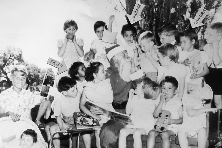 Young children lining up for a group photo.