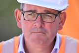 A close-up photograph of Daniel Andrews, with a hard hat slightly visible on his head and orange high-vis slightly visible.