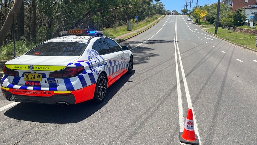 NSW Police vehicle parked on road blocking access.