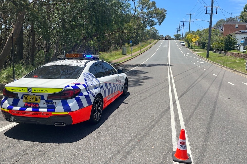 NSW Police vehicle parked on road blocking access.