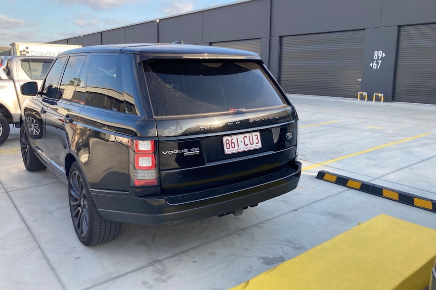 a black car parked in a car park