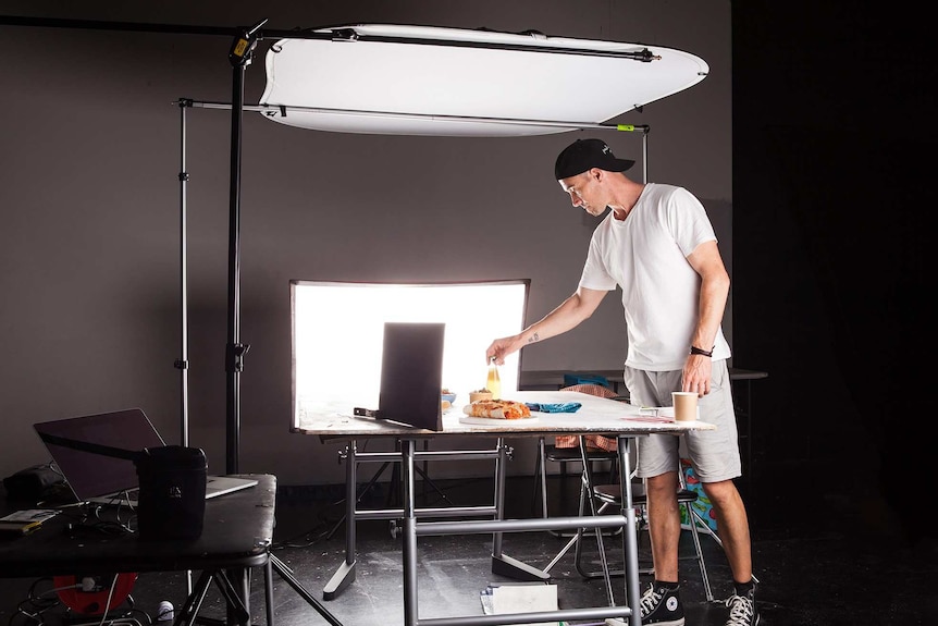 Food photographer Paul Williams setting up props and lighting for a shoot