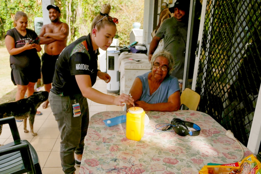 An elderly woman prepares for vaccination.