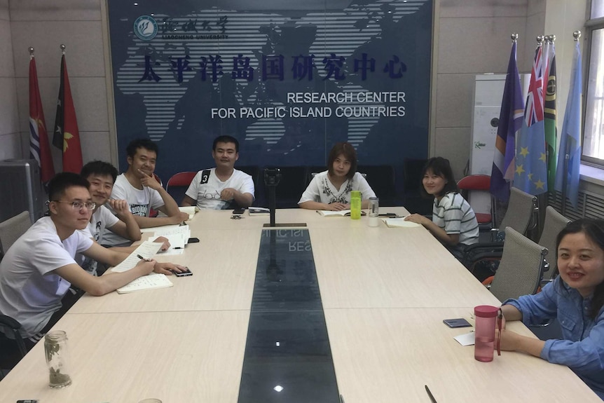 Students at Liaocheng University gather around a table for a Samoan language class.