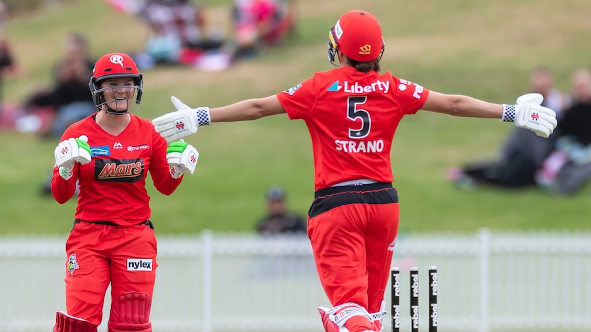 Melbourne Renegades Courtney Webb (left) looks at Molly Strano, with arms outstretched, after a WBBL win over the Sydney Sixers.