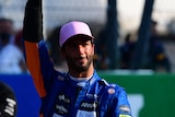 race car driver waving to crowd 