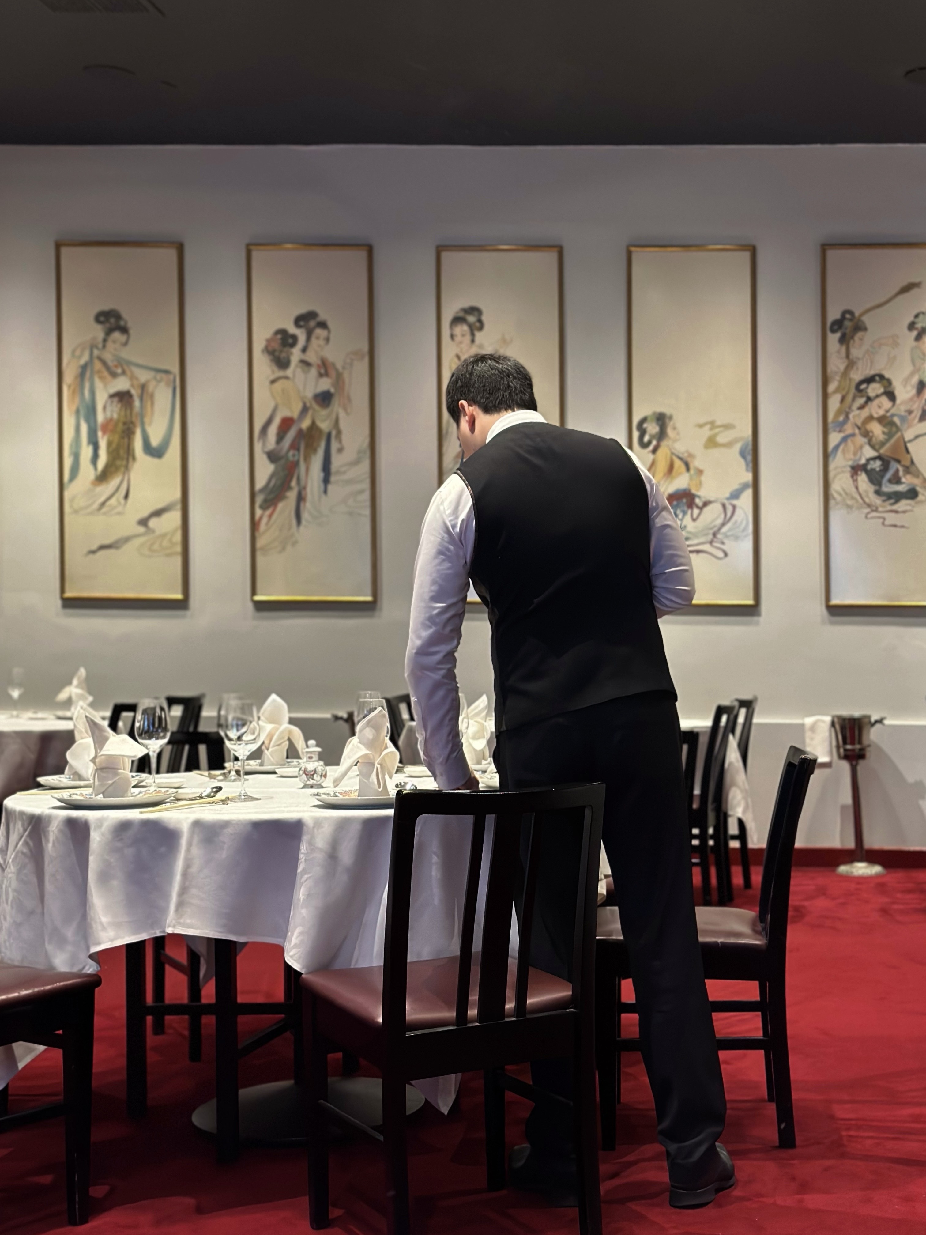 A waiter sets the table at Melbourne's Flower Drum restaurant