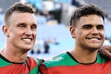 Jack Wighton and Latrell Mitchell stand arm in arm at a South Sydney Rabbitohs NRL game.