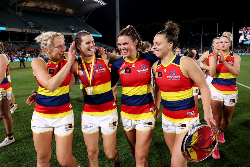 Marijana Rajcic, Chelsea Randall, Anne Hatchard and Ebony Marinoff of the Crows celebrate their win over Port