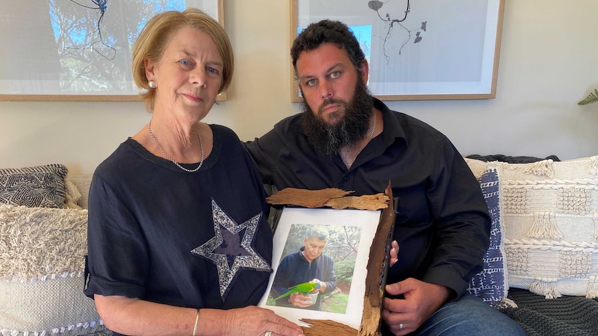 Man and a woman holding a photo