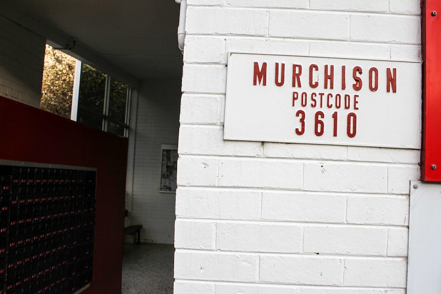A painted brick wall with a sign reading "Murchison postcode 3610".