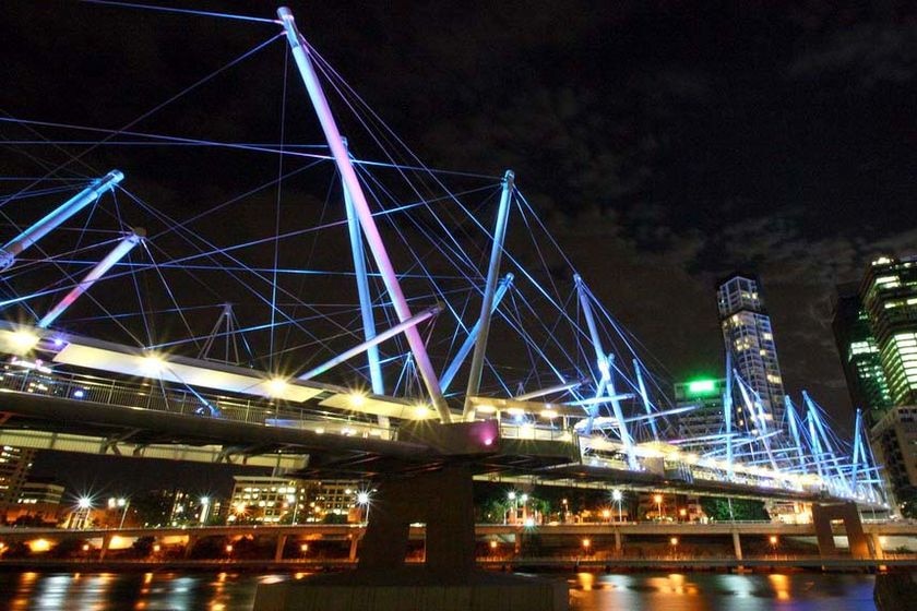 Coloured lighting illuminates the Kurilpa Bridge