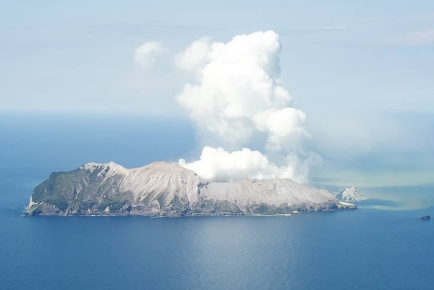 An island with plumes of smoke rising above it