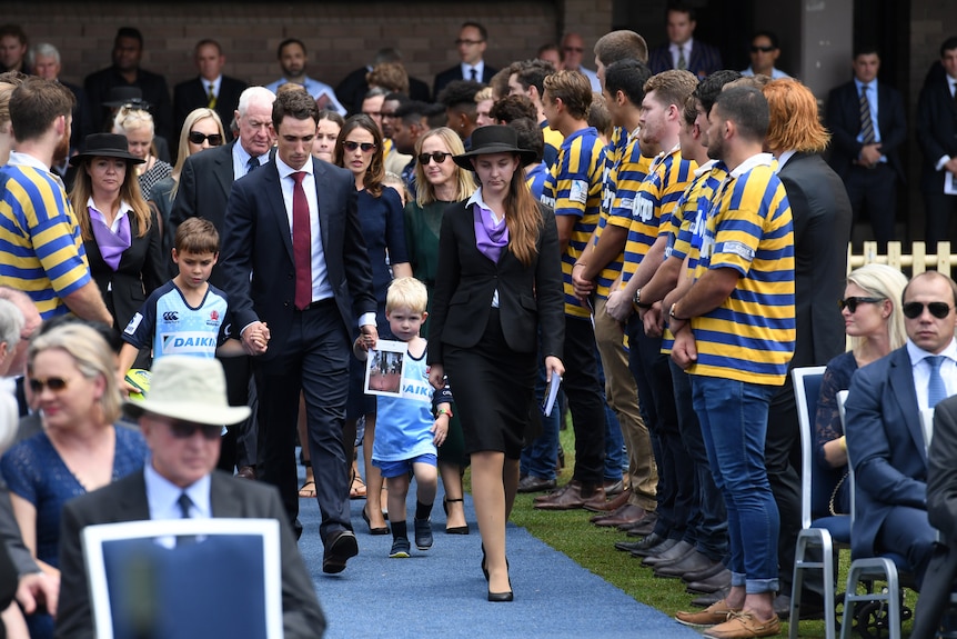 Dan Vickerman's children, Joseph and Xavier arrive at a public memorial service for their father at the University of Sydney